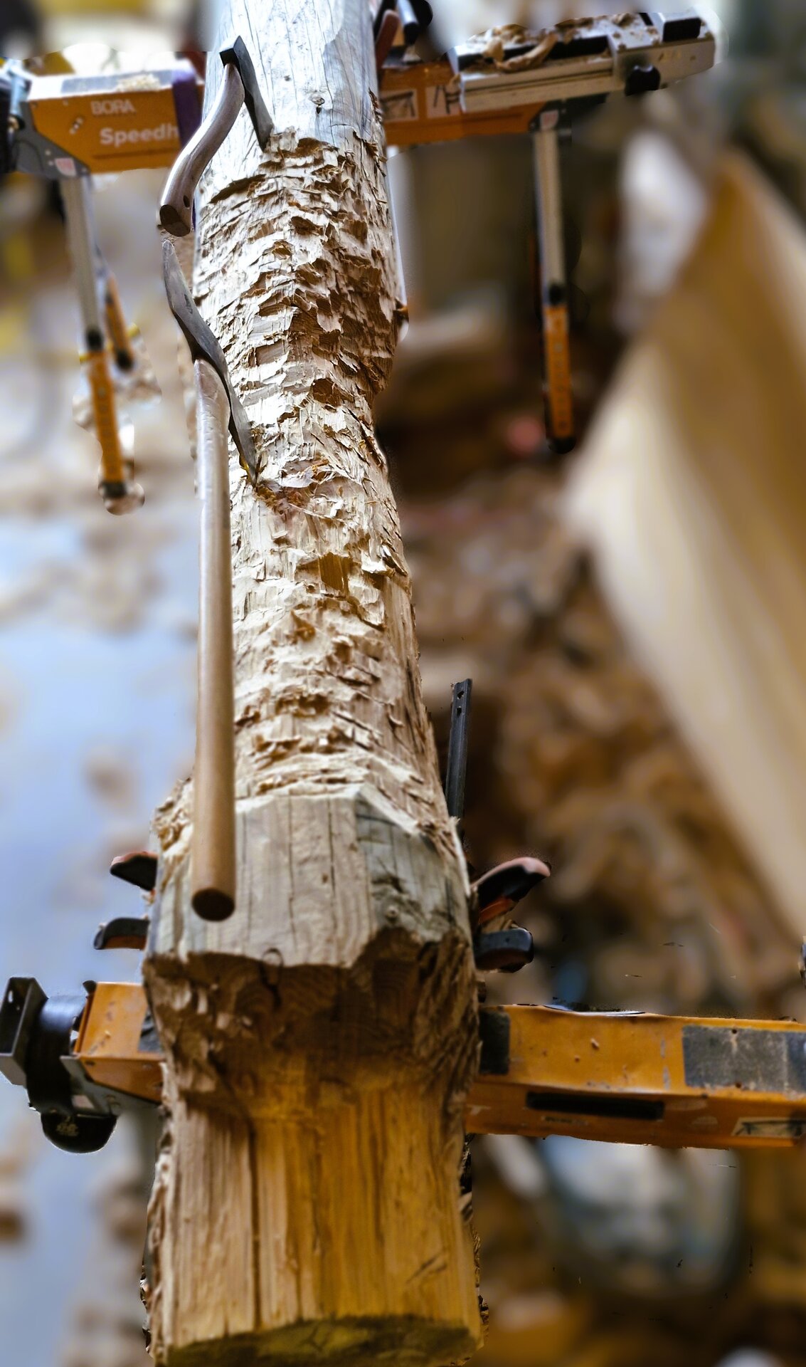 Hand-carving in progress — scale texture being cut into the timber face
